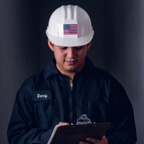Man Wearing FlexStyle American Flag Emblem on White Hard Hat