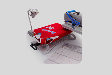 Jersey placed on heat press with Stand Alone Laser Alignment System sitting next to it