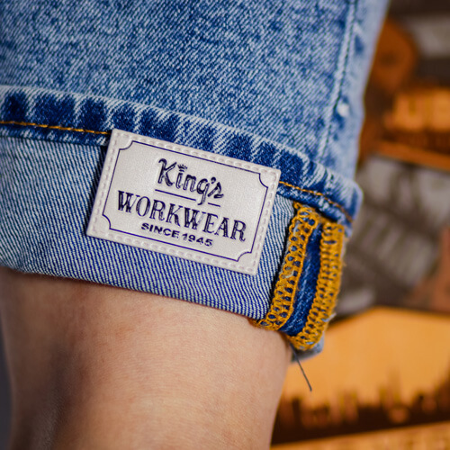 Woman's ankle wearing cropped jeans with a FlexStyle Texture emblem attached to the cuff